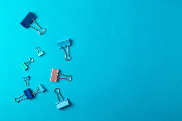 different stationary items and notebooks on the blue background. minimalism. flat lay