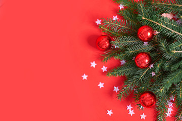 Christmas banner. Xmas design red christmas tree decorations and glitter silver confetti on a red background. Horizontal christmas poster, greeting cards, headers, website.