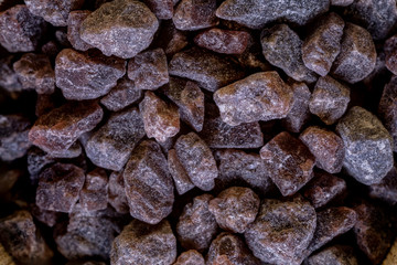 Kala namak or Black salt of South Asia on a wooden spoon