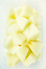 Small pieces of freshly cut melon in white bowl