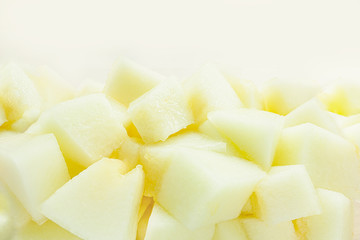 Small pieces of freshly cut melon in white bowl