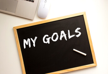 The text is written in chalk on a slate board. business concept