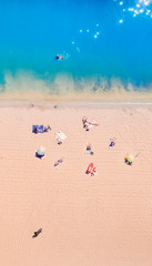 Vertical Shot of Top view of the azure Resort Sea with beautiful water and people resting on the shore. Warm sand and azure clean water.