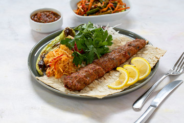 Adana kebab on white wood