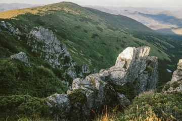 A herd of sheep grazing on a rocky hill