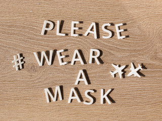 hashtag wear a mask. preventive health care notice sign with text PLEASE WEAR A MASK at entrance for coronavirus prevention. Compulsory measure in airport for face protection wearing.
