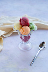 mixed ice cream in glass on white background
