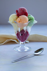 mixed ice cream in glass on white background