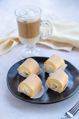 banana roll cake and coffee on a white background