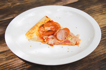 meat lovers pizza with topping pepperoni salami sausage and ham on wooden table