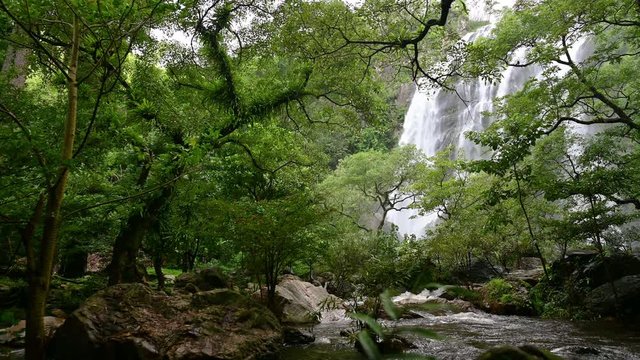 A beautiful waterfall deep in the tropical forest, steep mountain adventure in the rainforest.