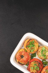 Colored stuffed peppers with potato, carrot, garlic, onion and parsley. Healthy food concept, top view. Free space for text.