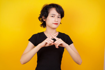 Young beautiful brunette girl wearing casual clothes over isolated background standing against gray...