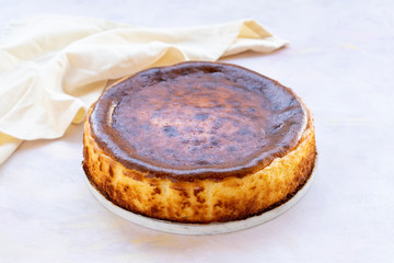 Fototapeta premium San Sebastian Cheesecake on White Wood