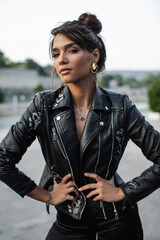 Fototapeta na wymiar Beautiful woman posing in black leather jacket
