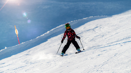 Fototapeta na wymiar Cute Child Skiing Down the Slope