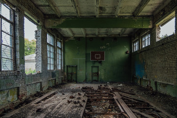 Ruined gymnasium in abandoned school