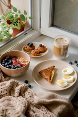 Breakfast with granola, eggs, coffee and cakes