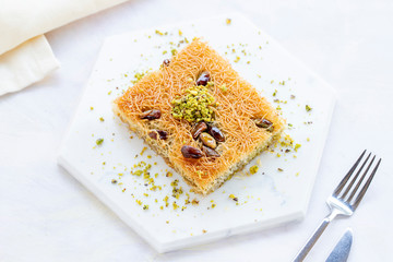 sherbet kadayif dessert on white wood