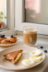 Breakfast with granola, eggs, coffee and cakes