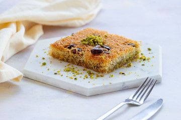 sherbet kadayif dessert on white wood