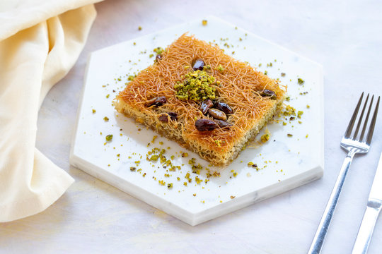 sherbet kadayif dessert on white wood