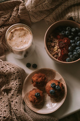 Breakfast with granola, coffee and cakes