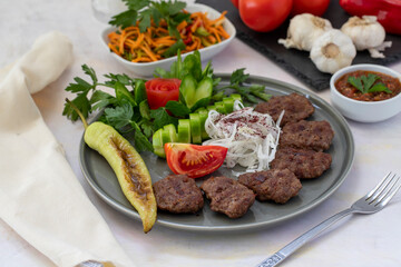 Delicious Turkish traditional kebab meatballs on white plate. Turkish Food Kofte or Kofta (meatball).