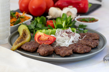 Delicious Turkish traditional kebab meatballs on white plate. Turkish Food Kofte or Kofta (meatball).