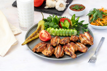 Chicken wings on the grill. Grilled chicken wings on a white background
