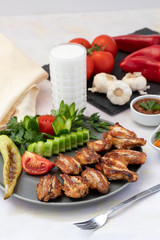 Chicken wings on the grill. Grilled chicken wings on a white background