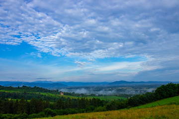 Obraz premium morning mountain landscape with blue sky and clouds