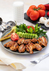 Chicken wings on the grill. Grilled chicken wings on a white background