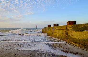 Wooden groyne/breaker in the North Sea used to defend the fragile cliffs from coastal erosion.
