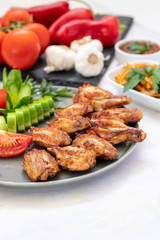 Chicken wings on the grill. Grilled chicken wings on a white background