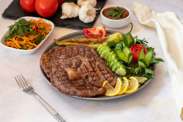 Isolated grilled beef steak on a wooden board