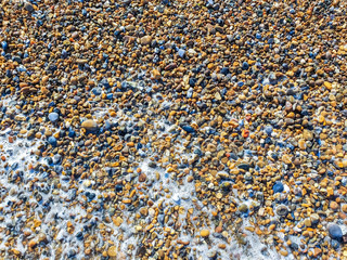 pebbles on british seaside beach on sunny day