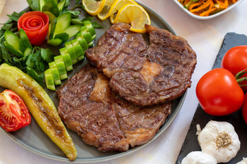 Isolated grilled beef steak on a wooden board