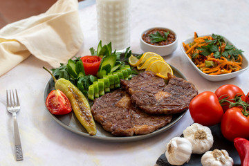 Isolated grilled beef steak on a wooden board