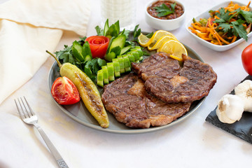 Isolated grilled beef steak on a wooden board