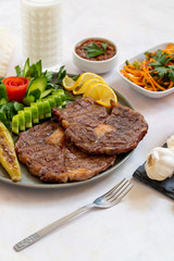 Isolated grilled beef steak on a wooden board