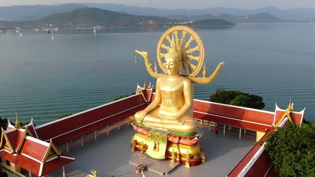 Buddha temple. Aerial view of big golden Buddha statue monument with sea on background in Koh Samui, Thailand.