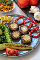 cheddar mushrooms - baked cheddar mushrooms on a white background