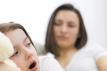 Close up view of happy gorgeous young mother with little candid daughter.