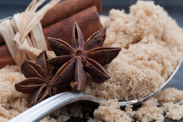 Star Anise, Cinnamon and Brown Sugar with Sterling Silver Spoon on Rustic Background
