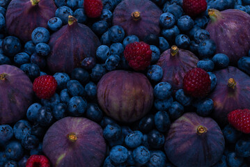 Blueberries, figs, raspberries background.