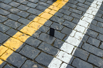 Fototapeta premium Picture smartphone on the stones paving.