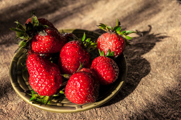 strawberries on a plate, harsh light