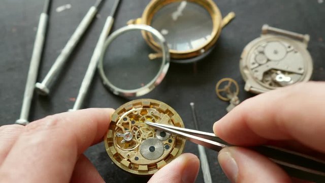 Watchmaker is repearing mechanical wrist watch