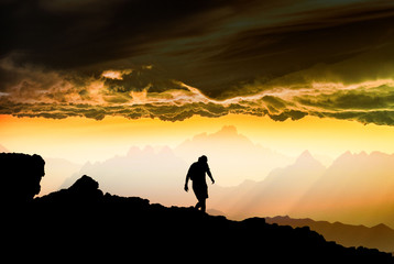 silhouette of a man standing on a rock